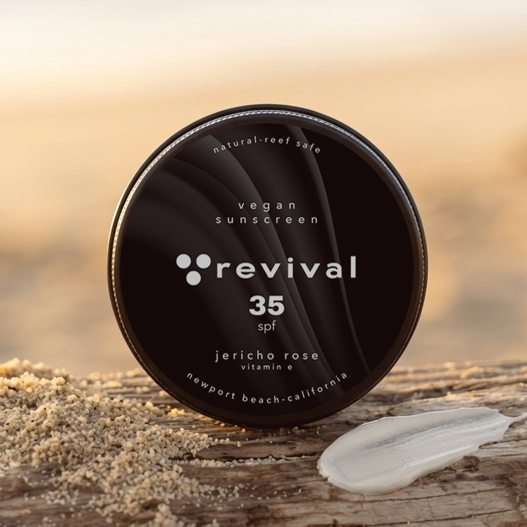 Vegan 35 spf sunscreen propped up on log with a white smear of sunscreen.